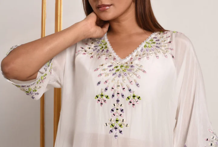 Detail of pastel mosaic hand embroidery and V-neck on Iris White Kurta Suit Set by Embrowhite