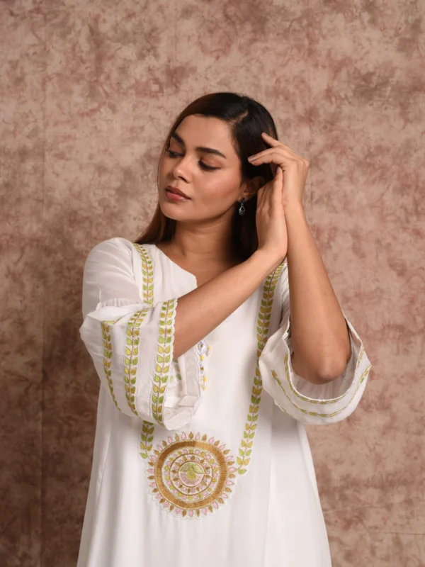 Front mid-shot of Solana white and gold sun embroidered A-line kurta top by EmbroWhite