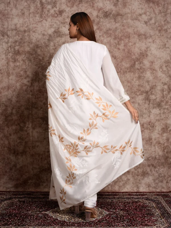 Full-length back view showing dupatta draped across shoulders with gold leaf motifs on Aurelian ivory suit set by Embrowhite