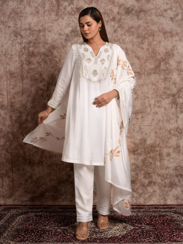Full-length front view of Aurelian ivory suit set featuring gold leaf hand motifs, embroidered yoke, and matching dupatta by Embrowhite