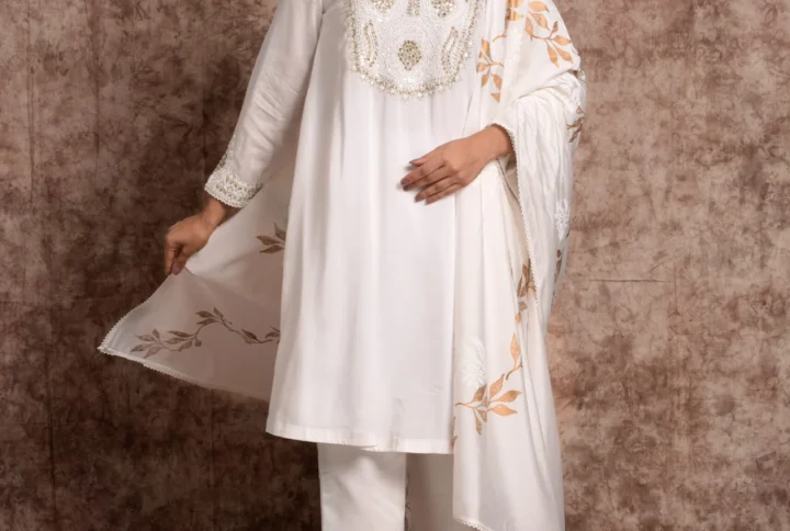 Full-length front view of Aurelian ivory suit set featuring gold leaf hand motifs, embroidered yoke, and matching dupatta by Embrowhite