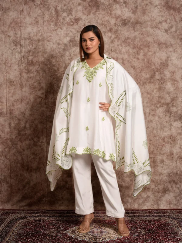 Full-length front view of Kashvi white kurta set with green folk-art embroidery, matching scalloped dupatta, and straight pants by Embrowhite