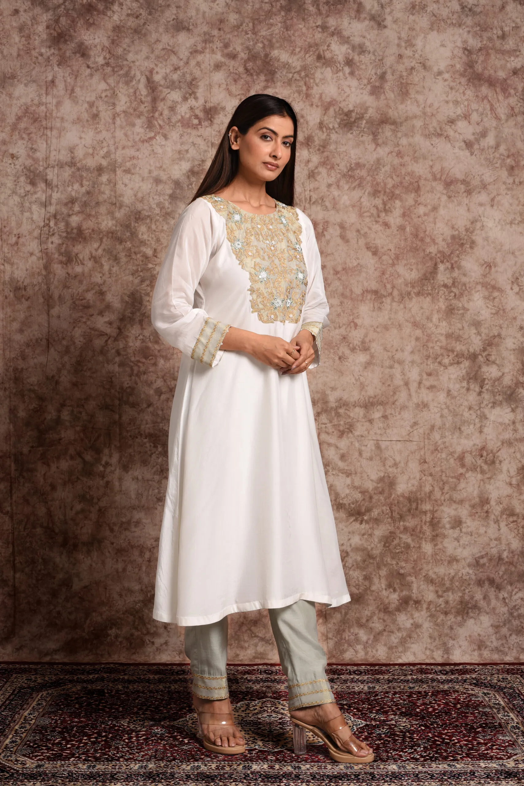 Full-length side standing shot of model in Verbena mint green kurta set showing cuff embroidery and tailored trousers by Embrowhite Full-length side standing shot of model in Verbena mint green kurta set showing cuff embroidery and tailored trousers by Embrowhite