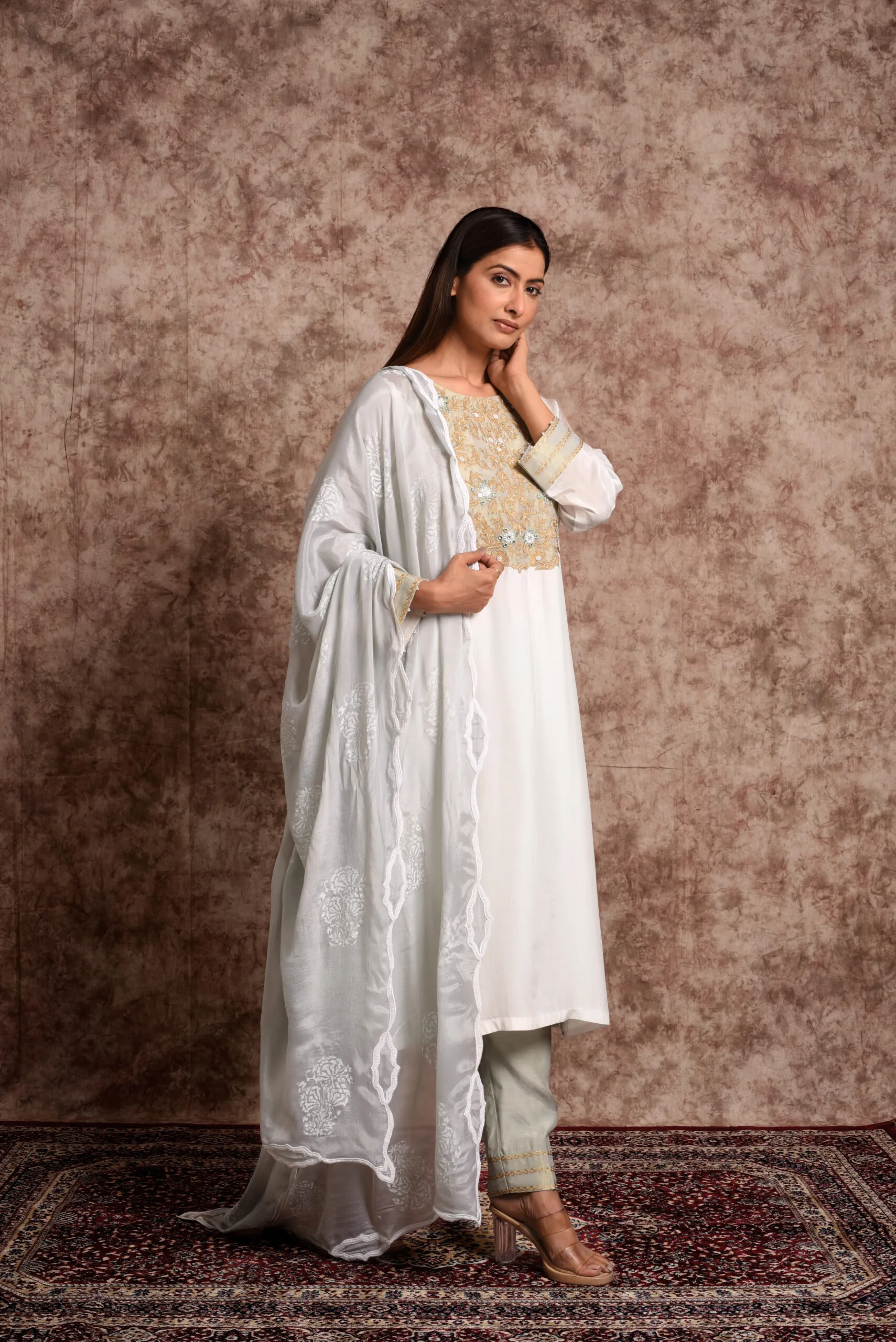 Three-quarter full-length shot of Verbena mint suit set featuring sheer organza dupatta with scalloped borders by Embrowhite Three-quarter full-length shot of Verbena mint suit set featuring sheer organza dupatta with scalloped borders by Embrowhite