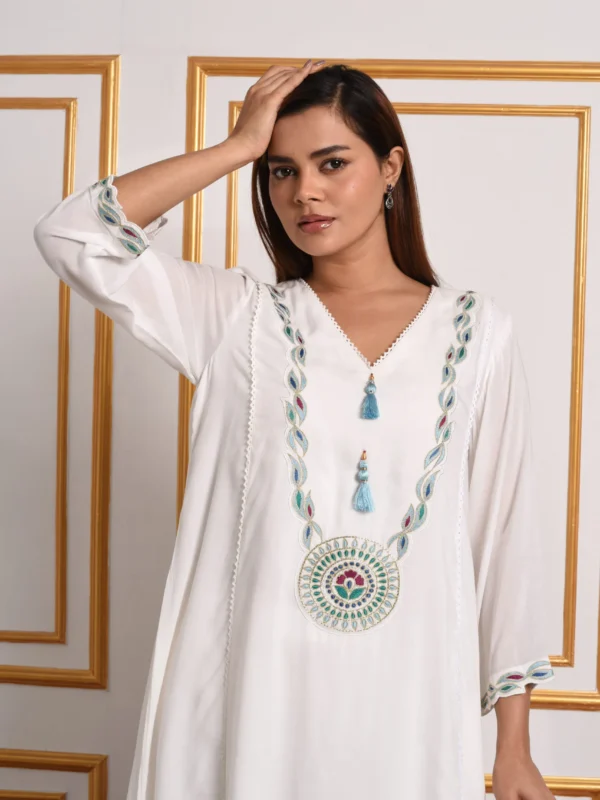 Three-quarter full-length view of Kyra sun-kissed ivory kurta set highlighting sleeve embroidery and straight-leg trousers by Embrowhite