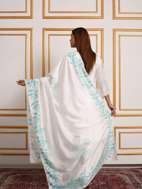 Back view of model displaying white dupatta with turquoise blue botanical vine print from EmbroWhite Nilaya set