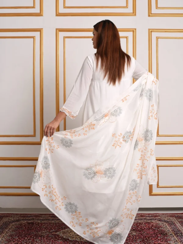 Back view of model holding printed white matching dupatta paired with Vanya kurta set by Embrowhite