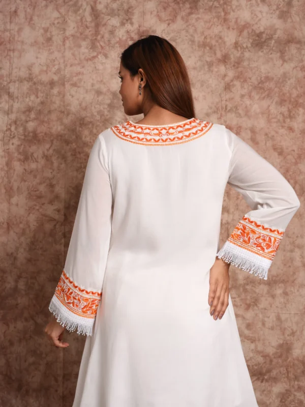 Back view of model wearing EmbroWhite Floriana ivory short kurta suit with fringe hem