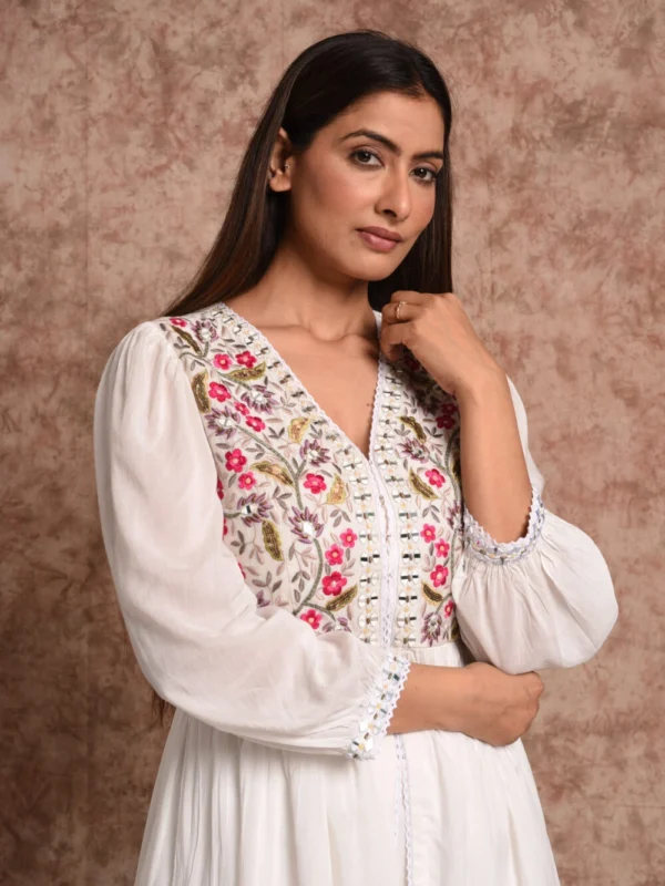 Close up detail of hand embroidered floral V-neck bodice on Zinnia ivory front open tunic by EmbroWhite