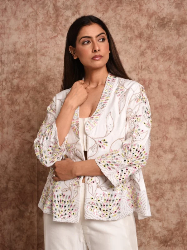 Close-up details of embroidered jacket on Aamani Coral Pillar white Indo-Western outfit by EmbroWhite