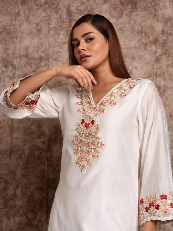 Close up shot highlighting V-neck floral thread embroidery and wide sleeve cuffs on EmbroWhite Zoya kurta
