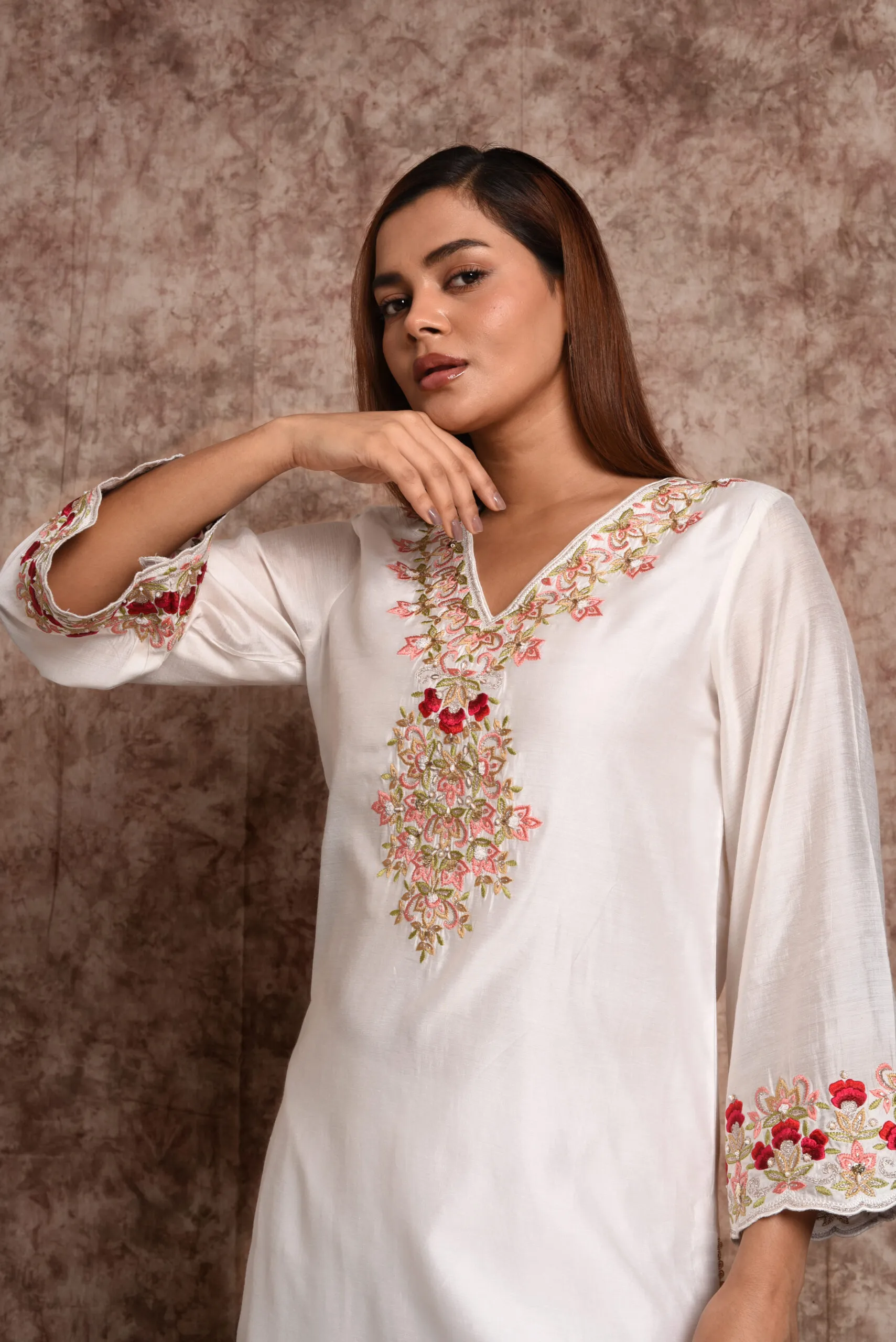 Close up shot highlighting V-neck floral thread embroidery and wide sleeve cuffs on EmbroWhite Zoya kurta Close up shot highlighting V-neck floral thread embroidery and wide sleeve cuffs on EmbroWhite Zoya kurta