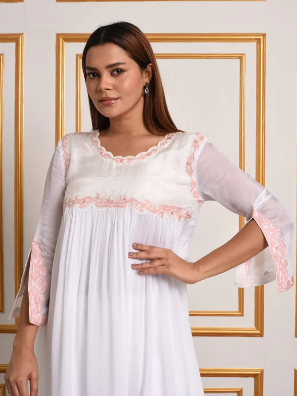 Close up view of EmbroWhite Inara ivory co-ord tunic featuring pink scalloped embroidered yoke