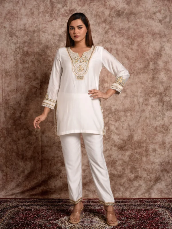 Front catalog pose of Sage Radiance off-white short kurta featuring gold-embroidered neckline yoke by Embrowhite