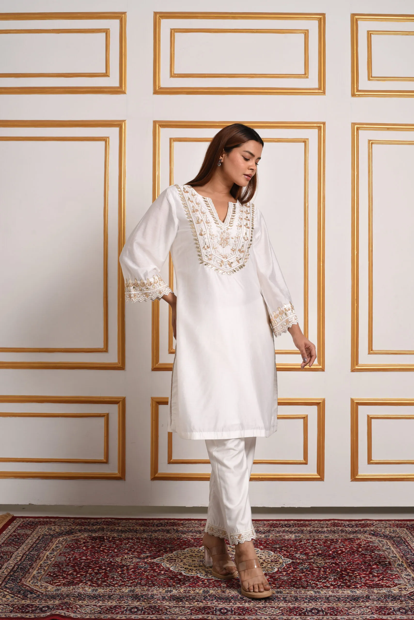 Front pose of model in EmbroWhite ivory silk kurta set with gold embroidered neckline Front pose of model in EmbroWhite ivory silk kurta set with gold embroidered neckline
