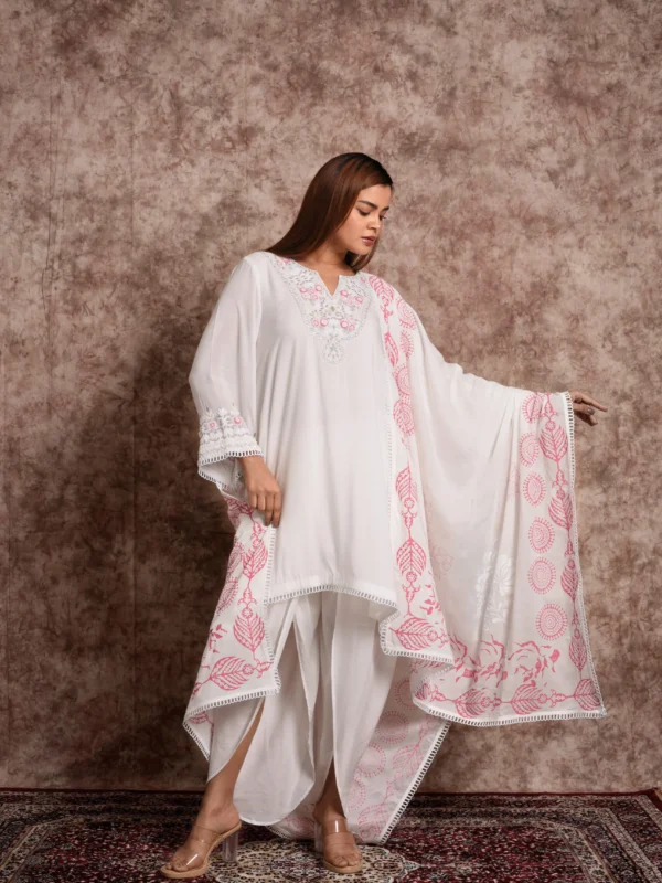 Front view of model wearing EmbroWhite Flora ivory kurta with dhoti pants and draped pink printed dupatta
