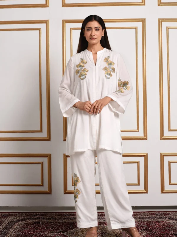 Full-length catalog view of Noor ivory short tunic co-ord set with mustard floral embroidery and wide-leg pants by Embrowhite