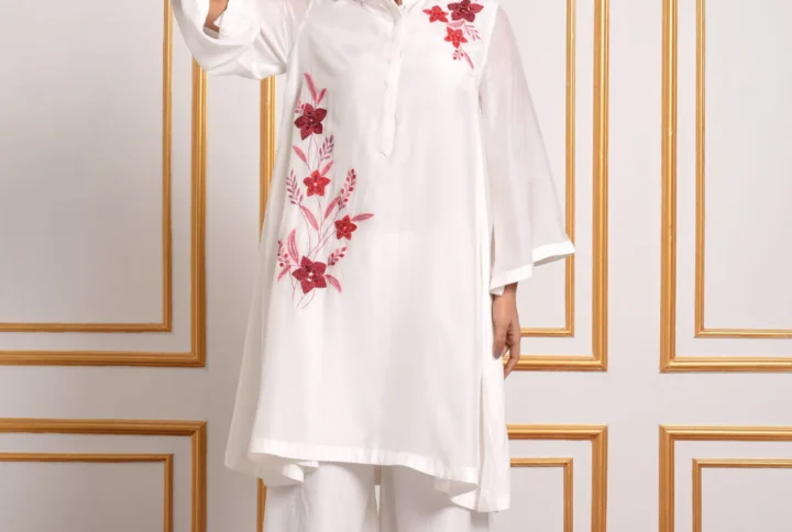 Full length front pose of model in EmbroWhite Amara white embroidered A-line tunic paired with embroidered palazzo pants
