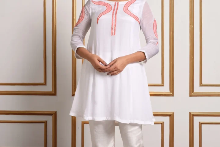 Full-length front view of Aira white co-ord set featuring coral peach vine embroidery on tunic and straight pants by Embrowhite