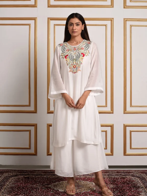 Full-length front view of Iris off-white kurta with palazzo set featuring pastel floral mosaic bib embroidery and bell sleeves by Embrowhite