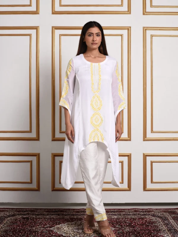 Full-length front view of Meher Jade Botanical white kurta set featuring high-low hem and yellow botanical motif embroidery