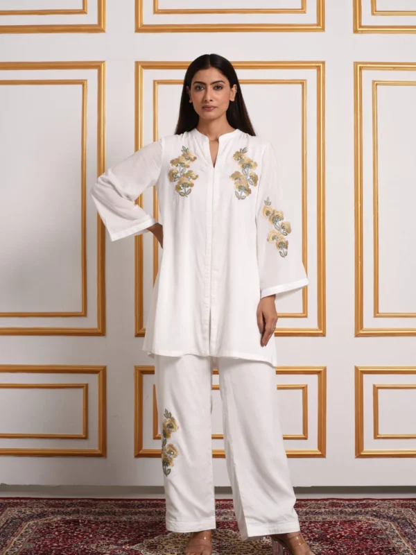 Full-length front view of Noor ivory co-ord set featuring mustard floral embroidered short tunic and trousers by Embrowhite