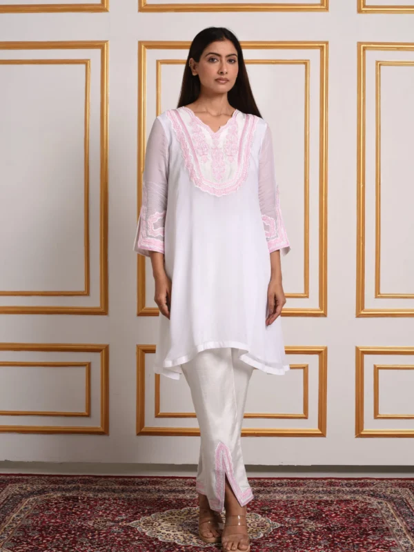 Full-length front view of model in Inaya Verdant Bloom white co-ord tunic set paired with matching pink embroidered slit trousers