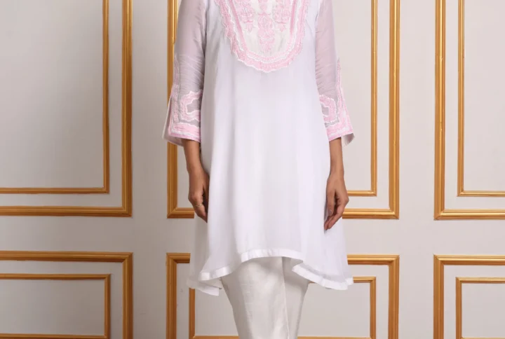 Full-length front view of model in Inaya Verdant Bloom white co-ord tunic set paired with matching pink embroidered slit trousers