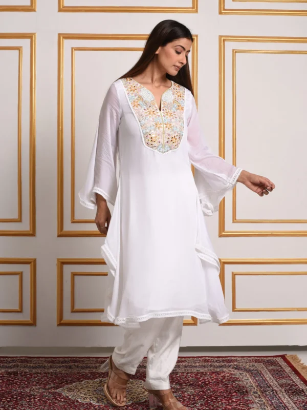 Full-length front walking shot of Solana white flared kurta set with gilded embroidery and straight pants by Embrowhite