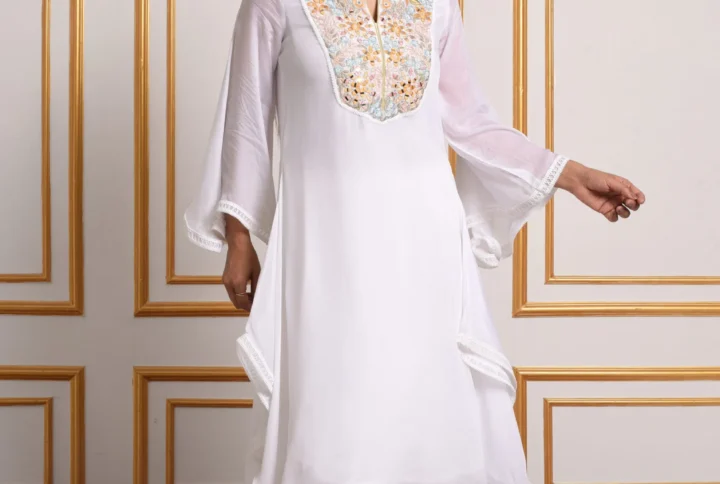 Full-length front walking shot of Solana white flared kurta set with gilded embroidery and straight pants by Embrowhite