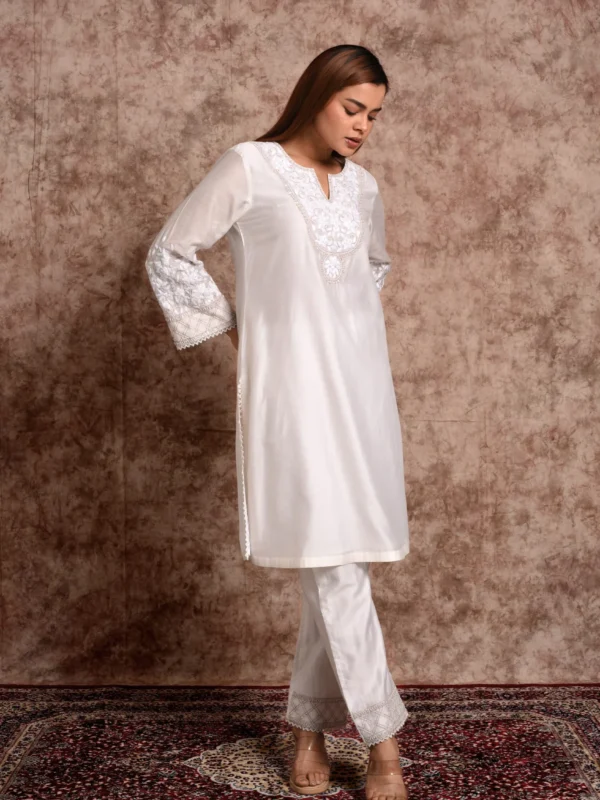 Full-length view of Kaira white embroidered short tunic with matching straight trousers by Embrowhite