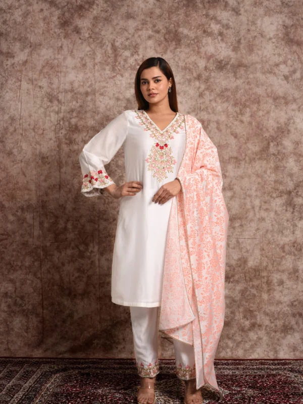 Full length view of model styling EmbroWhite Zoya white kurta set with draped light peach floral printed dupatta