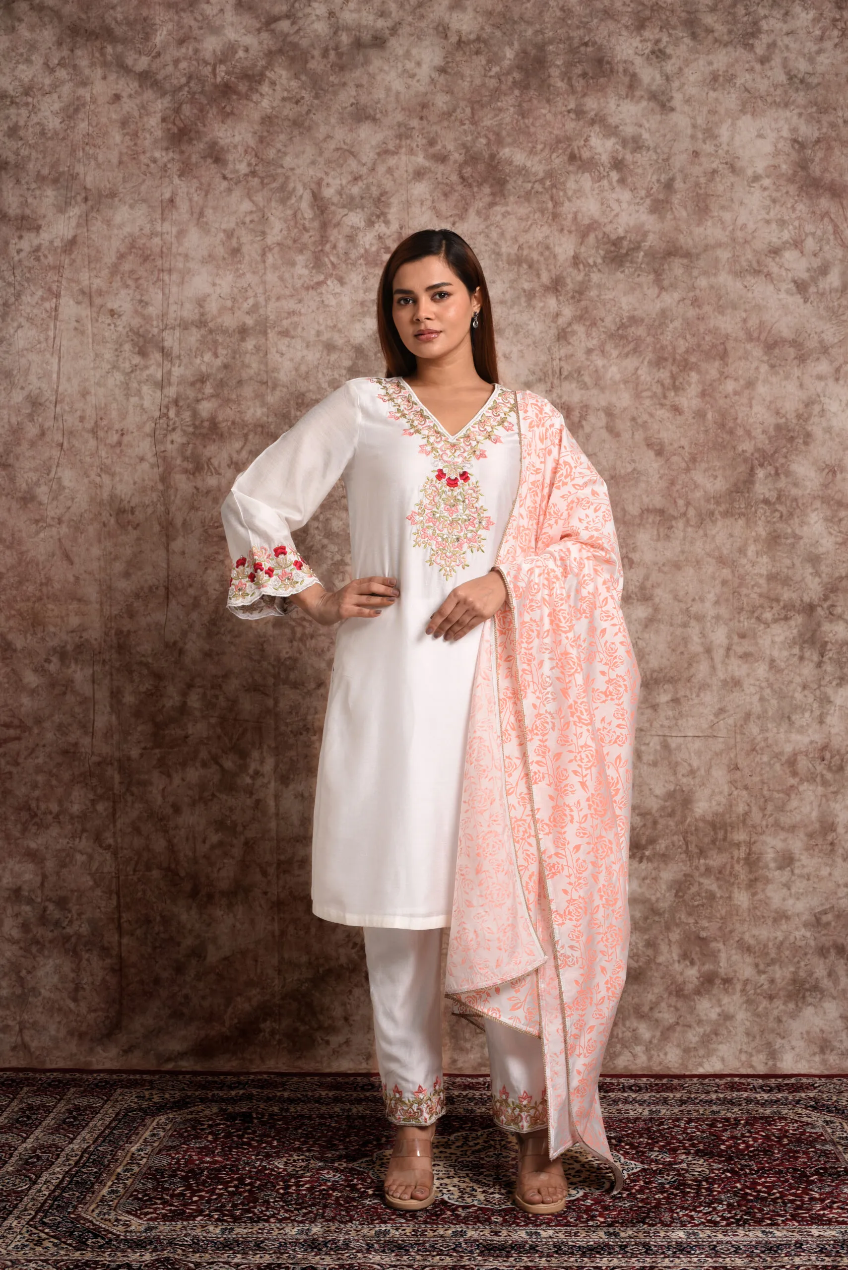 Full length view of model styling EmbroWhite Zoya white kurta set with draped light peach floral printed dupatta Full length view of model styling EmbroWhite Zoya white kurta set with draped light peach floral printed dupatta