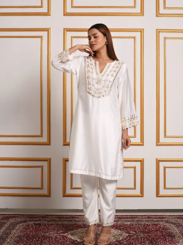 Full length view of model wearing EmbroWhite ivory and gold embroidered kurta pant set