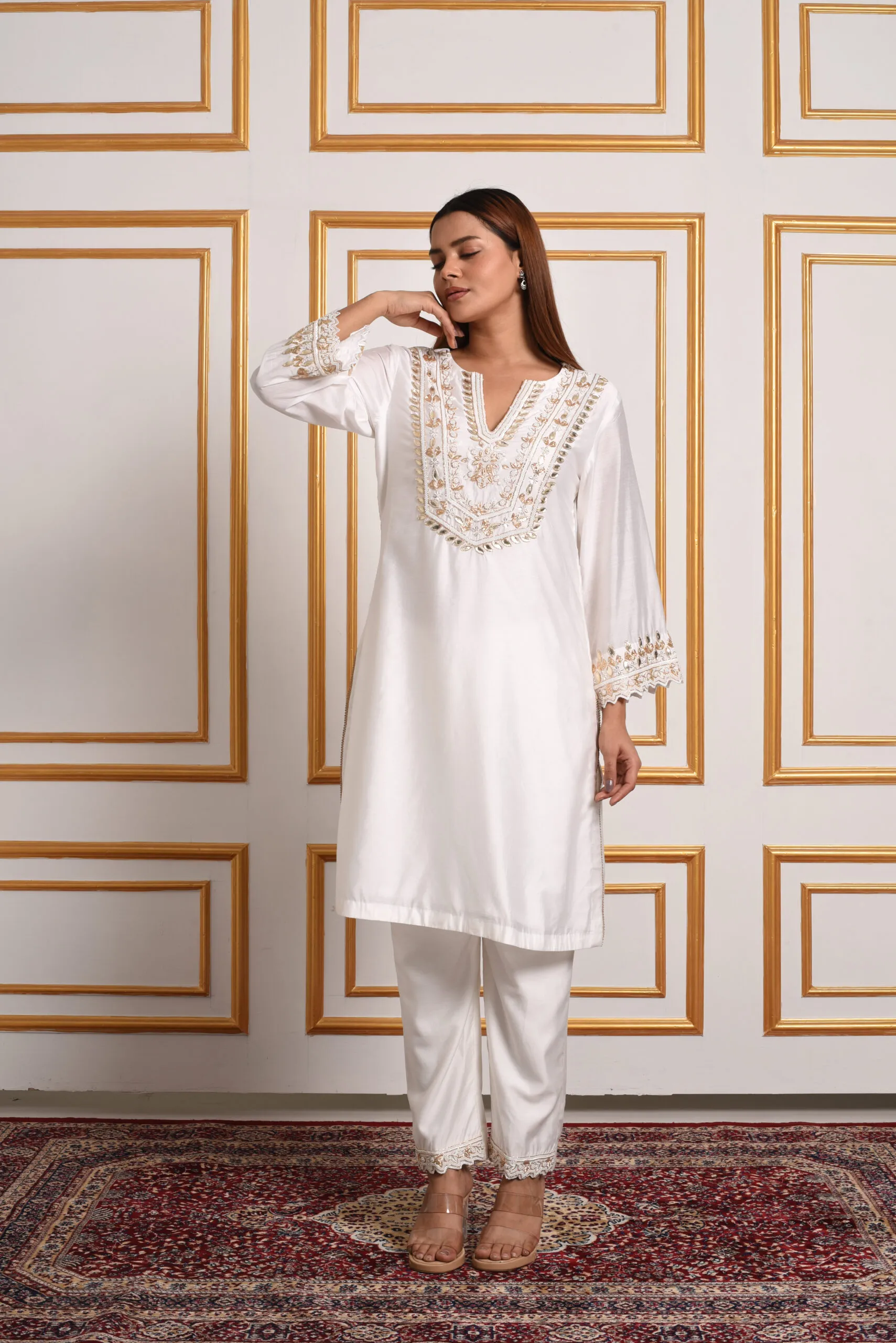 Full length view of model wearing EmbroWhite ivory and gold embroidered kurta pant set Full length view of model wearing EmbroWhite ivory and gold embroidered kurta pant set