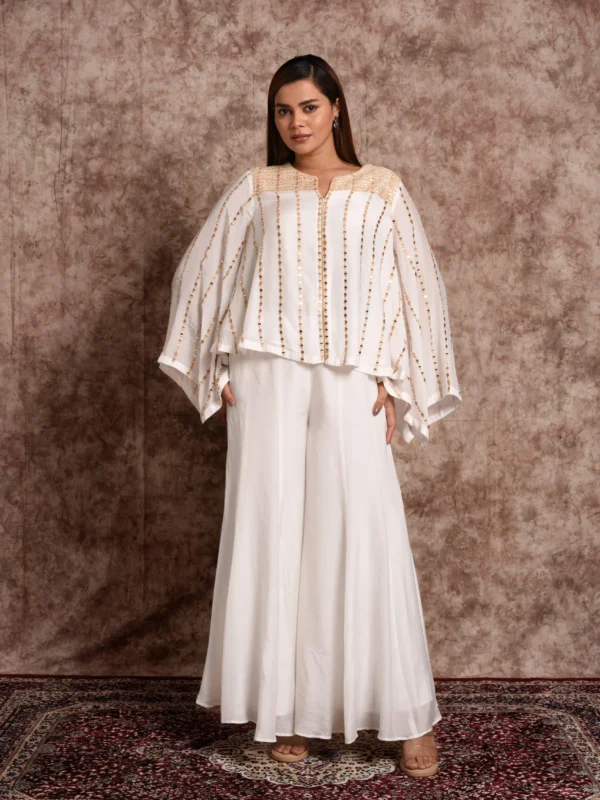 Model showcasing bell sleeves of EmbroWhite white kaftan top with palazzo outfit