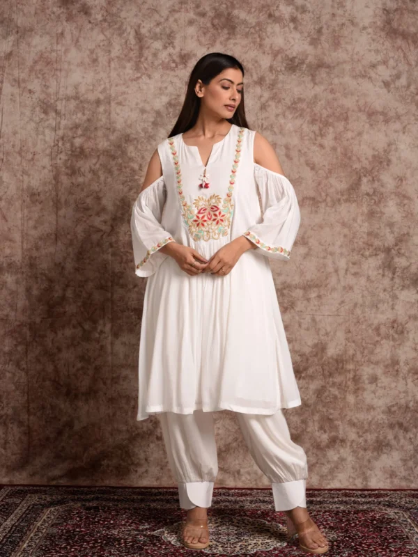 Model wearing Aamani white short flared kurta set with shoulder cutout detail by Embrowhite