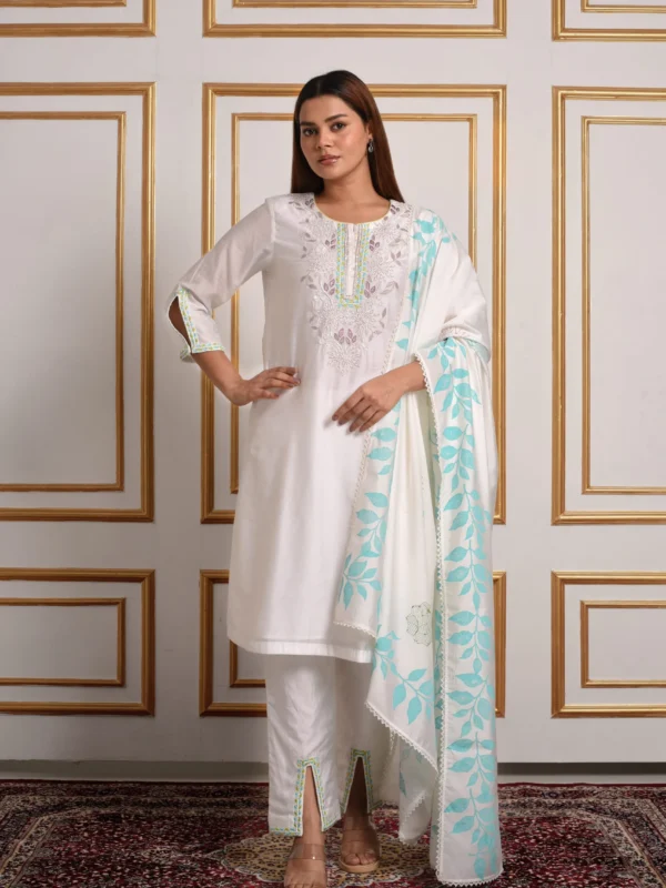 Model wearing EmbroWhite Nilaya white embroidered kurta set styled with draped blue leaf print dupatta