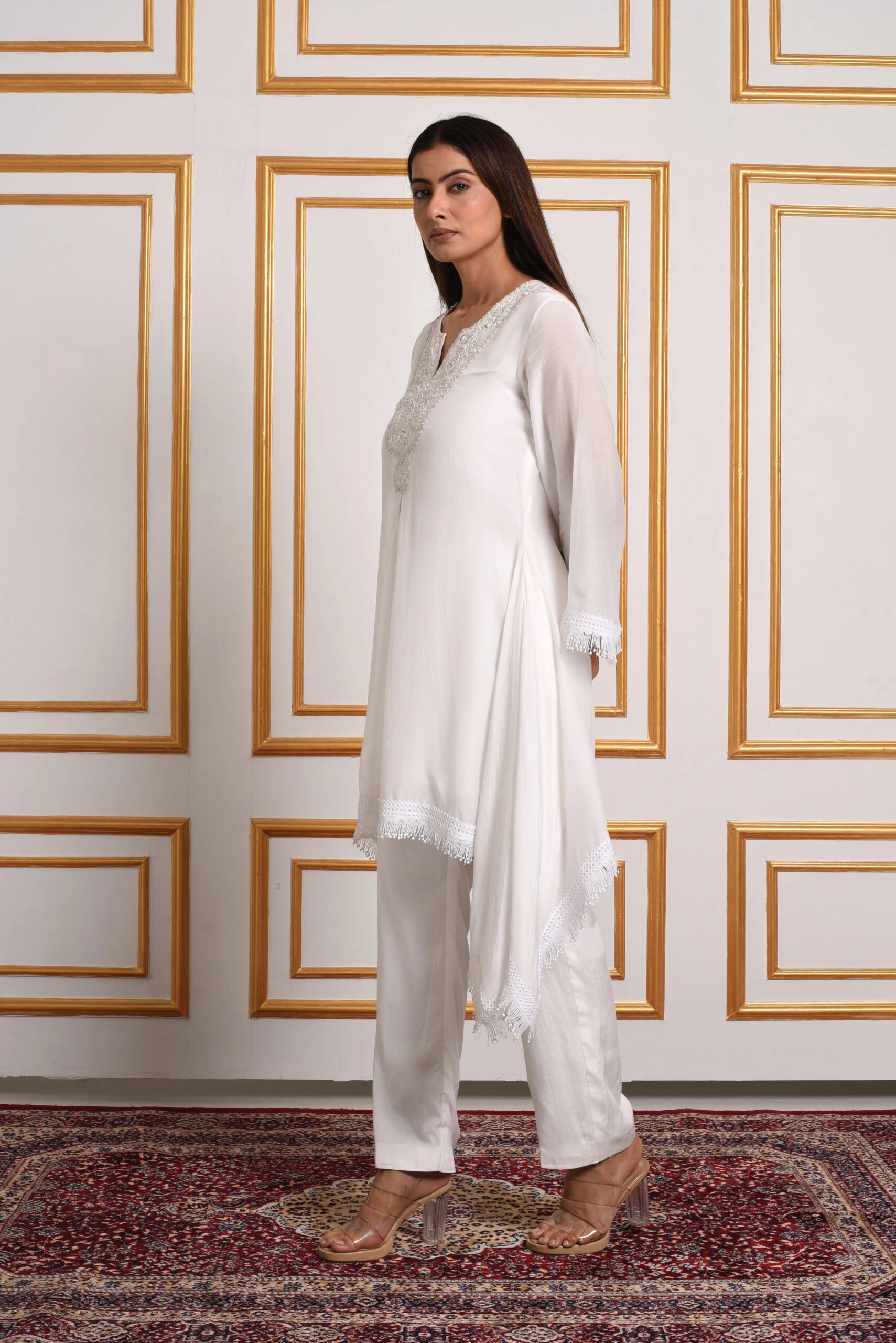 Side view of the Sunset Bouquet Heritage White Kurti Set highlighting the tassel trim by Embrowhite Side view of the Sunset Bouquet Heritage White Kurti Set highlighting the tassel trim by Embrowhite