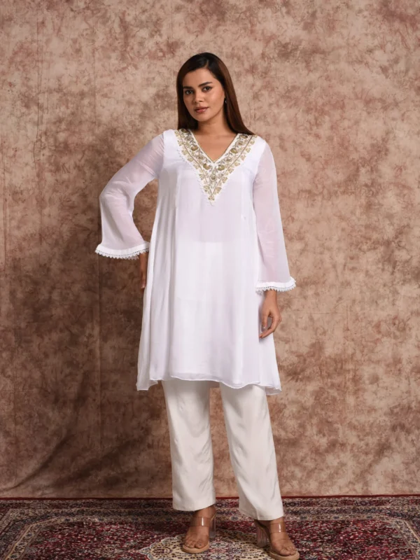 Three-quarter full-length shot of Pure Bloom Gilded white embroidered kurta set with scalloped lace sleeves by Embrowhite