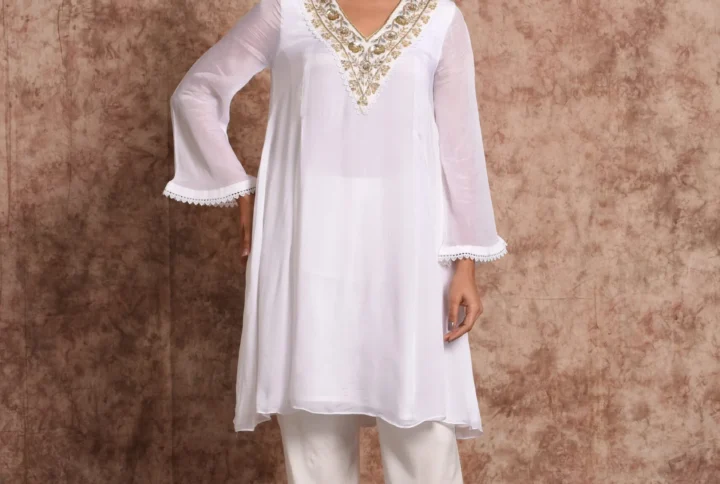 Three-quarter full-length shot of Pure Bloom Gilded white embroidered kurta set with scalloped lace sleeves by Embrowhite