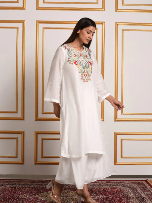 Three-quarter full-length view of Iris off-white kurta with palazzo set showing side profile and wide-leg flared trousers by Embrowhite