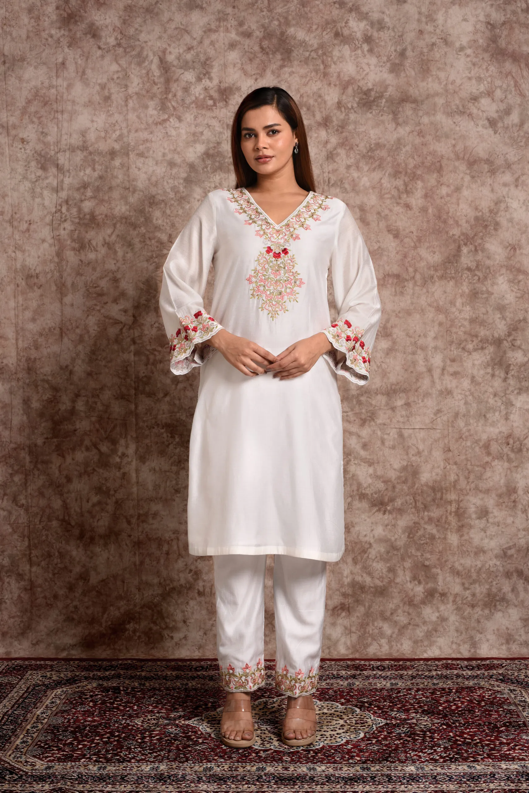 View of model posing in EmbroWhite Zoya silk kurta with intricate red rose floral embroidery on neck View of model posing in EmbroWhite Zoya silk kurta with intricate red rose floral embroidery on neck